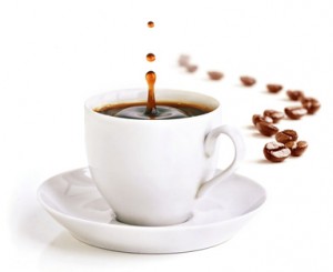 A cup of coffee with a splash of drops and coffee beans.