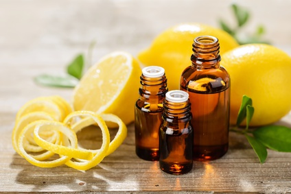lemon essential oil and lemon fruit on the wooden board, (taken with tilt shift lens)